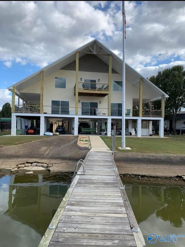 view of dock featuring a water view and a yard