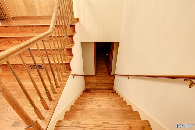 stairway featuring hardwood / wood-style flooring