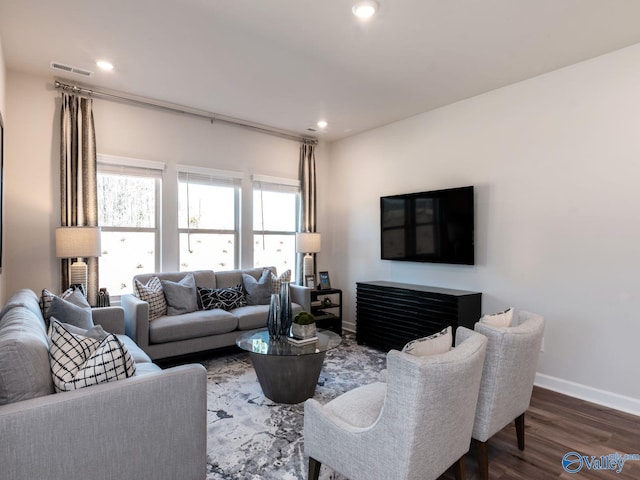 living room with recessed lighting, dark wood-type flooring, visible vents, and baseboards