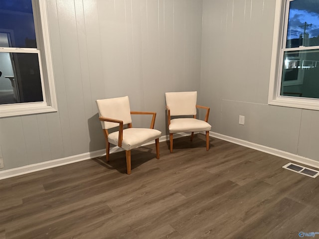 sitting room with dark wood-style floors, baseboards, and visible vents