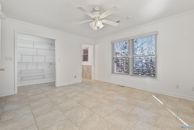 unfurnished bedroom with crown molding, baseboards, and ceiling fan