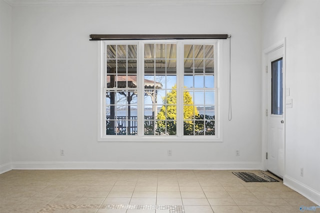 spare room with light tile patterned flooring and baseboards