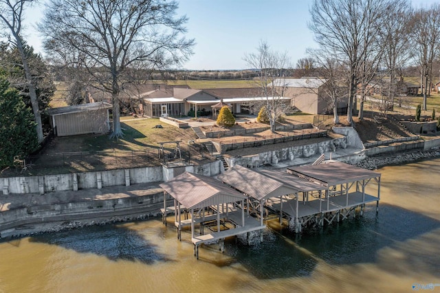 dock area featuring boat lift and a water view