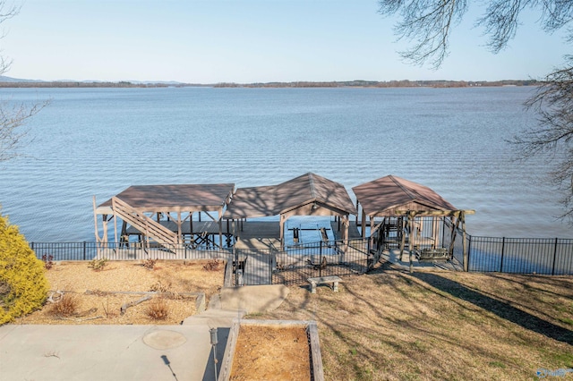 view of dock featuring a water view and fence