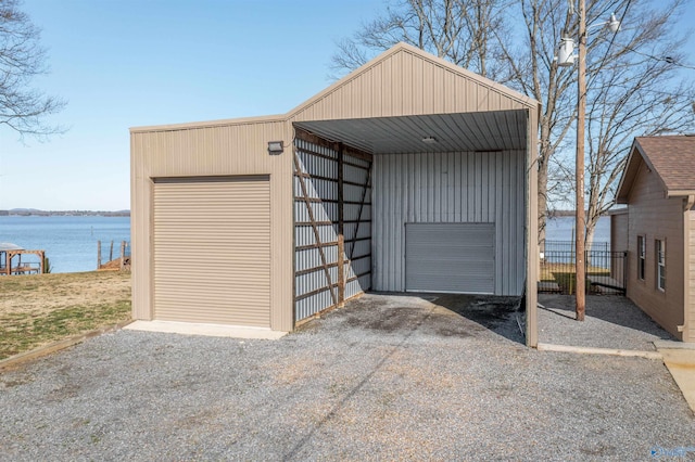 detached garage featuring a water view