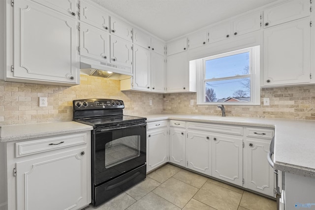 kitchen featuring under cabinet range hood, black / electric stove, white cabinets, and a sink