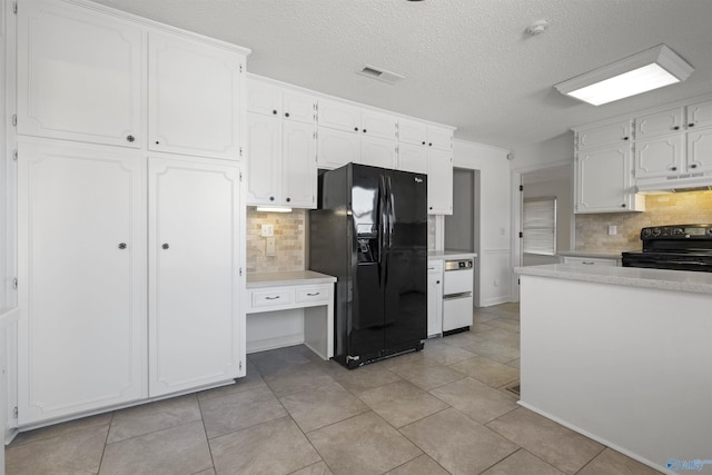 kitchen featuring visible vents, black appliances, white cabinets, light countertops, and under cabinet range hood