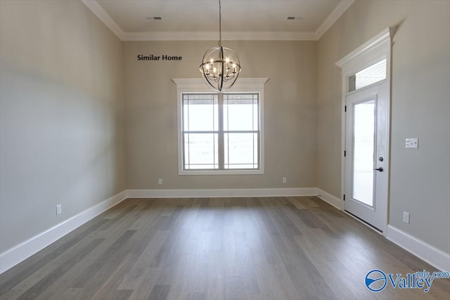 interior space featuring dark hardwood / wood-style flooring, ornamental molding, and a chandelier
