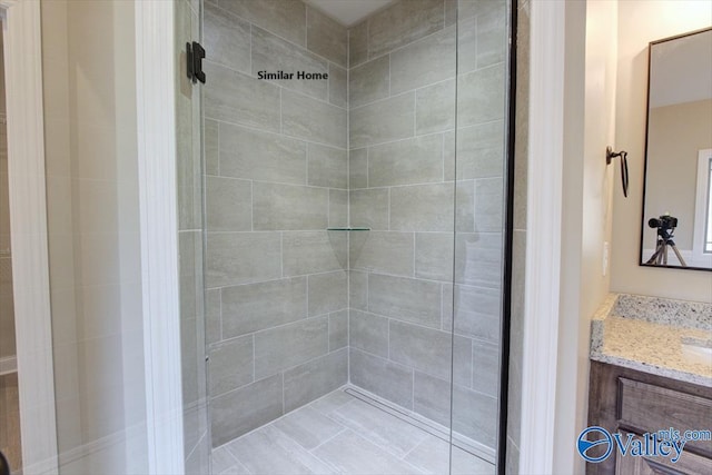 bathroom featuring vanity and tiled shower