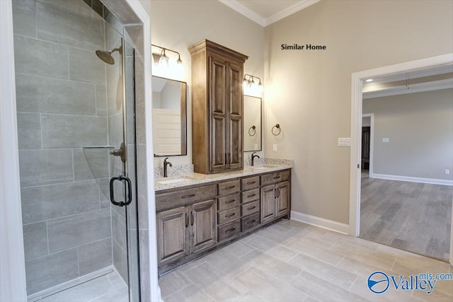 bathroom featuring walk in shower, vanity, and crown molding