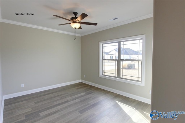 empty room with ceiling fan, ornamental molding, and wood-type flooring