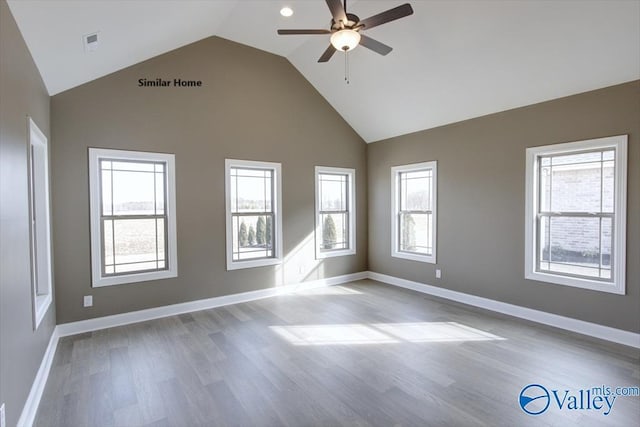 spare room featuring light hardwood / wood-style flooring, high vaulted ceiling, and ceiling fan