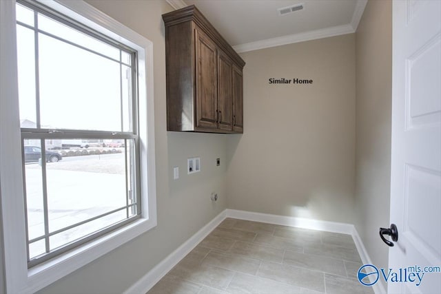 laundry room featuring crown molding, cabinets, gas dryer hookup, hookup for a washing machine, and electric dryer hookup