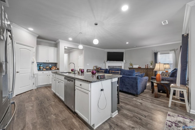 kitchen featuring sink, a kitchen island with sink, white cabinetry, stainless steel appliances, and dark hardwood / wood-style flooring