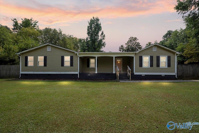 ranch-style house with a yard, crawl space, and fence