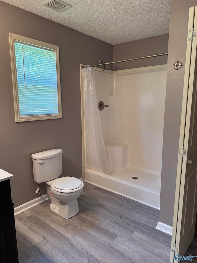 bathroom with a shower with curtain, vanity, toilet, and wood-type flooring