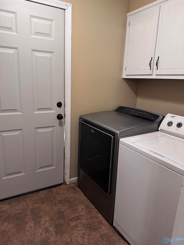 laundry area featuring cabinets and washer and clothes dryer