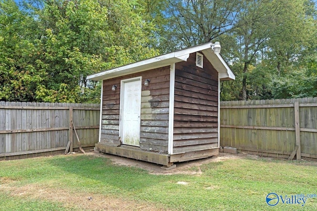 view of outdoor structure featuring a lawn