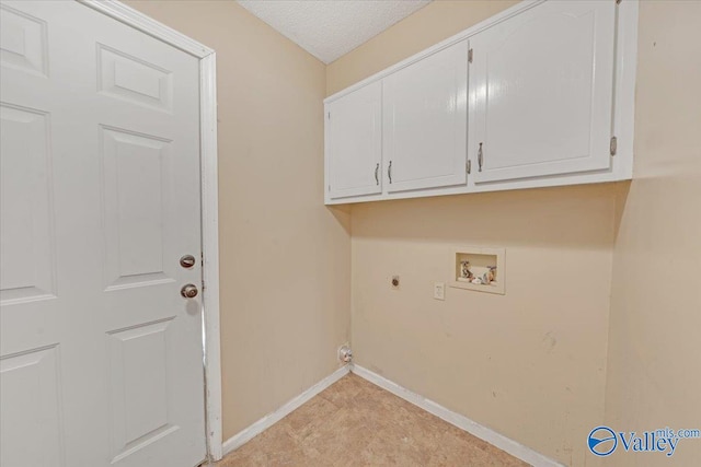 washroom with a textured ceiling, cabinets, electric dryer hookup, and washer hookup