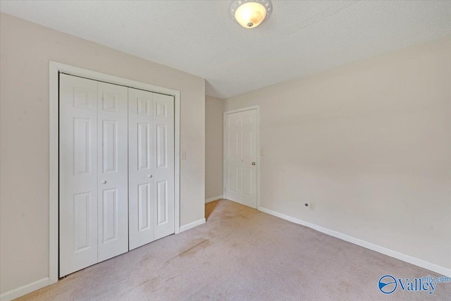 unfurnished bedroom featuring carpet floors, a closet, and baseboards