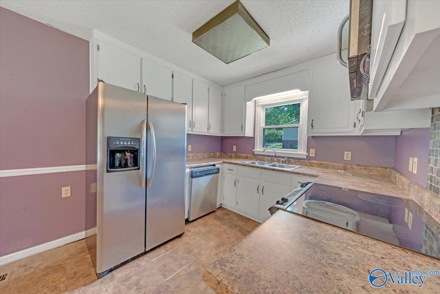 kitchen featuring a textured ceiling, sink, appliances with stainless steel finishes, and white cabinets