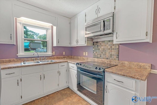 kitchen with black range with electric cooktop, sink, and white cabinets