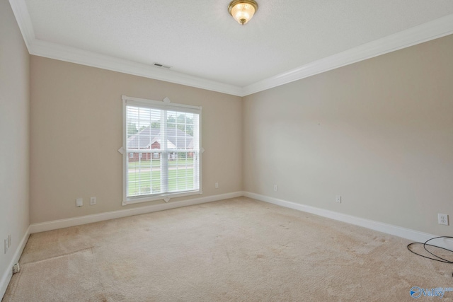 carpeted empty room featuring ornamental molding, visible vents, and baseboards