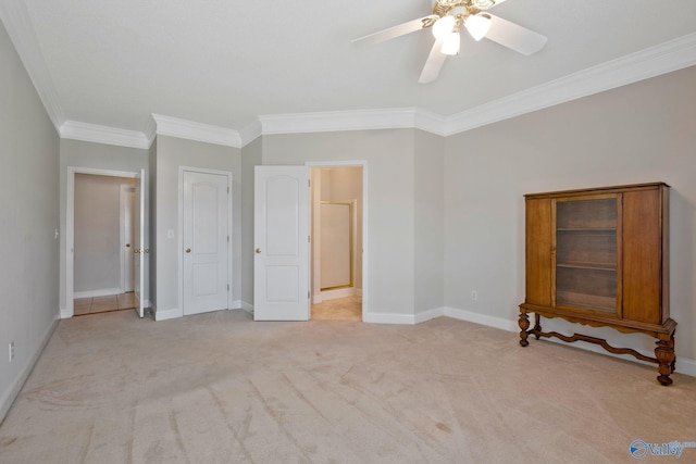 unfurnished bedroom featuring baseboards, ornamental molding, a ceiling fan, and light colored carpet