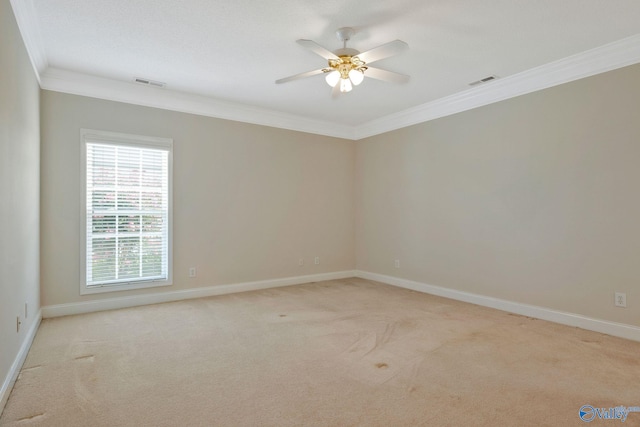 unfurnished room with ornamental molding, light colored carpet, and visible vents