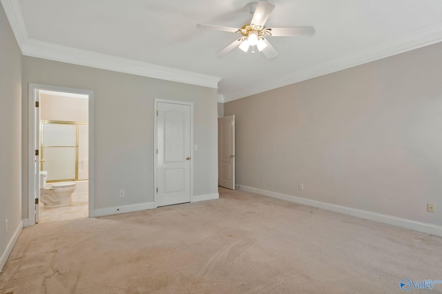 unfurnished bedroom featuring light carpet, ornamental molding, and baseboards