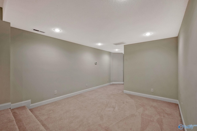 spare room with recessed lighting, baseboards, visible vents, and light colored carpet