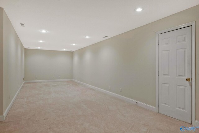 unfurnished room featuring light carpet, visible vents, baseboards, and recessed lighting