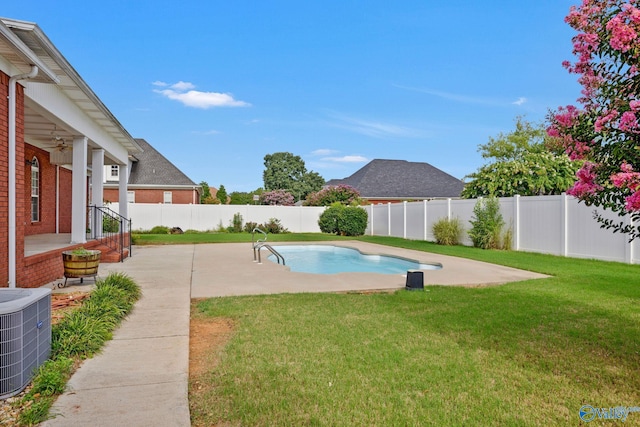 view of pool with cooling unit, a fenced backyard, a yard, and a patio