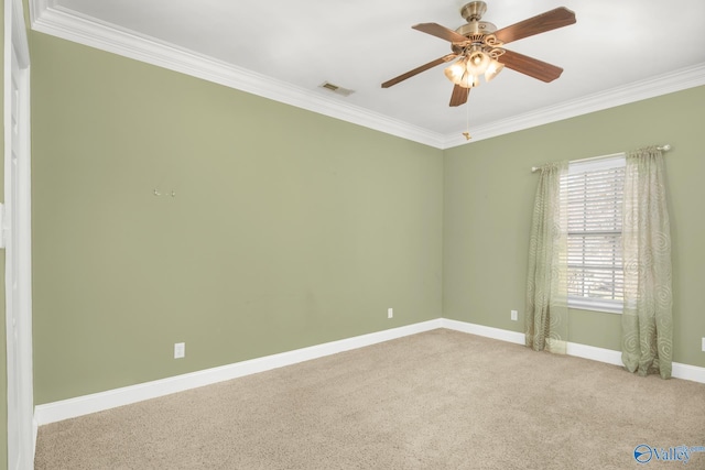 carpeted empty room with ceiling fan and ornamental molding