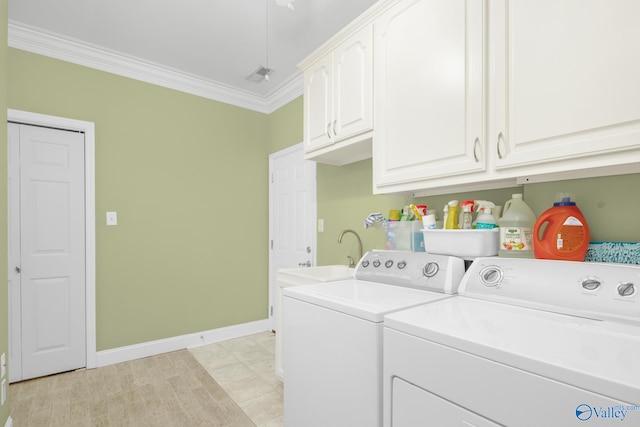 washroom featuring washer and clothes dryer, cabinets, sink, ornamental molding, and light tile patterned flooring