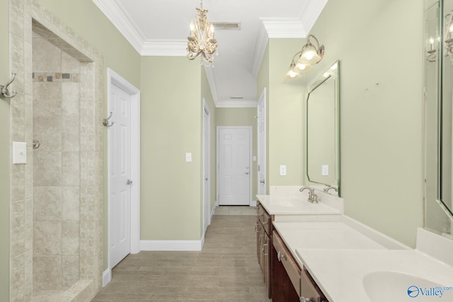 bathroom featuring vanity, crown molding, tiled shower, an inviting chandelier, and hardwood / wood-style floors