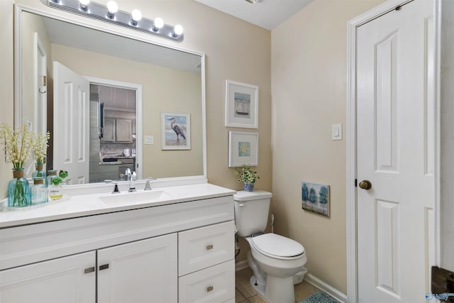 half bathroom featuring vanity, toilet, and baseboards