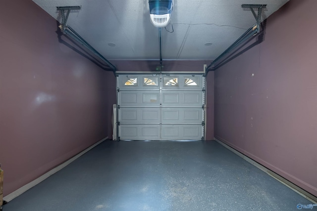 garage featuring a garage door opener and baseboards