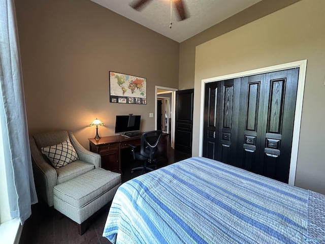 bedroom featuring dark wood-style floors, ceiling fan, a closet, and lofted ceiling