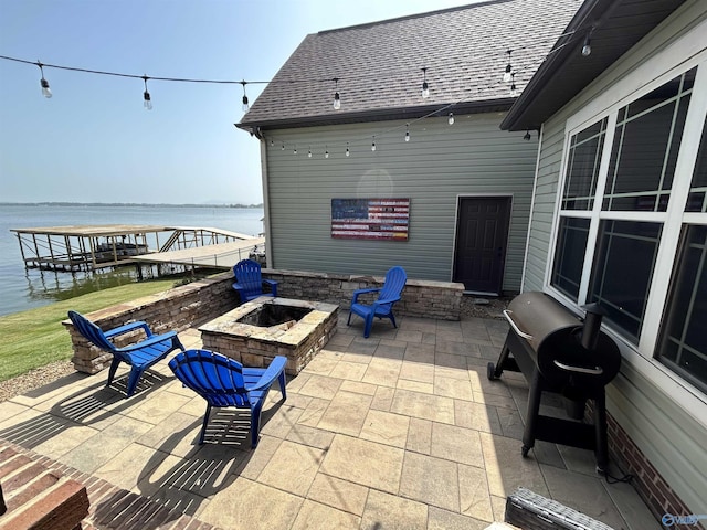 view of patio featuring a water view and an outdoor fire pit