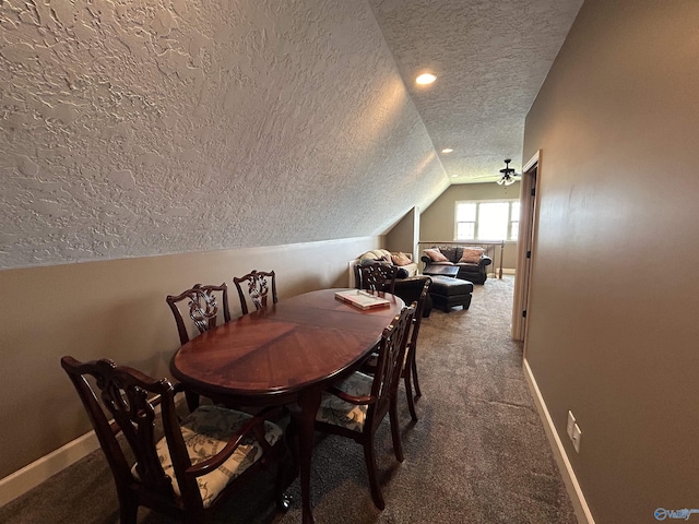 dining area with carpet, baseboards, vaulted ceiling, and a textured ceiling