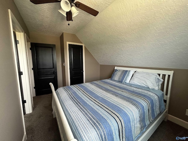 carpeted bedroom featuring vaulted ceiling, ceiling fan, a textured ceiling, and baseboards