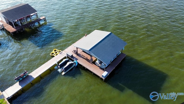 dock area with a water view and boat lift