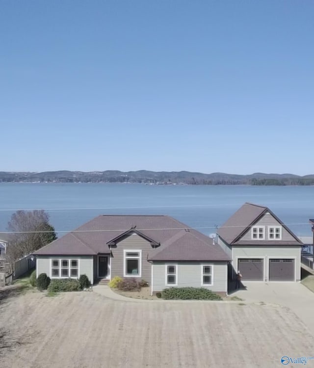 view of front facade with driveway and a water view