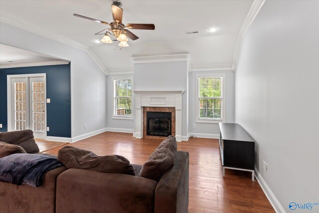 16968 Bellewood Dr, Athens, AL 35613 - living area with wood finished floors, a tiled fireplace, a ceiling fan, and visible vents