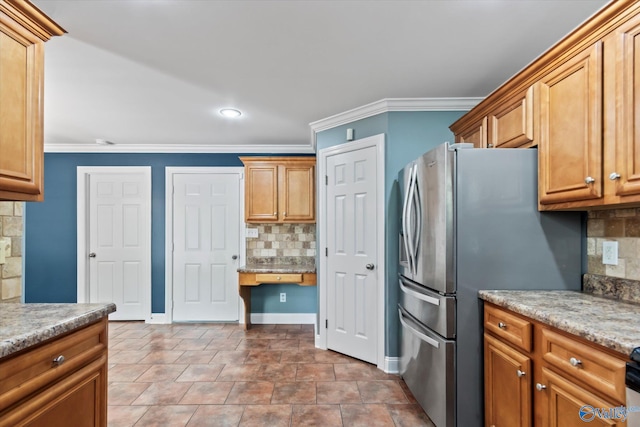 16968 Bellewood Dr, Athens, AL 35613 - kitchen with baseboards, ornamental molding, freestanding refrigerator, brown cabinets, and decorative backsplash