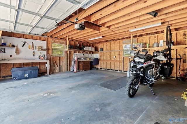 16968 Bellewood Dr, Athens, AL 35613 - garage with a garage door opener and a workshop area