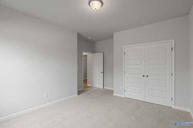 416 Tracer St, Huntsville, AL 35811 - unfurnished bedroom featuring a closet, baseboards, and carpet floors