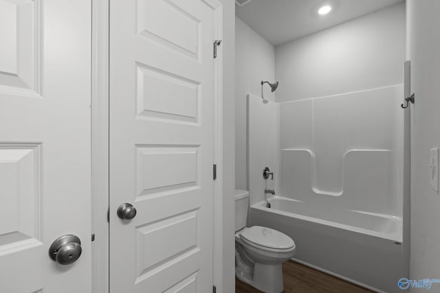 416 Tracer St, Huntsville, AL 35811 - bathroom with washtub / shower combination, toilet, and wood finished floors
