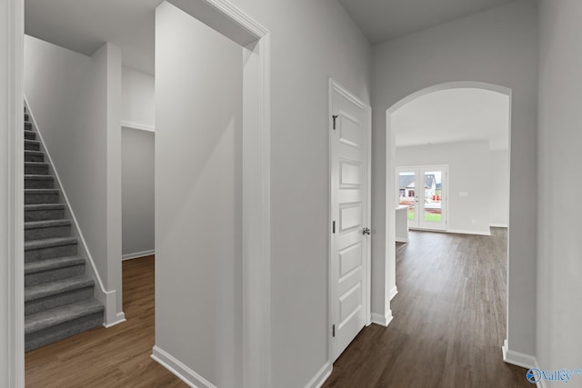 416 Tracer St, Huntsville, AL 35811 - hallway featuring arched walkways, stairway, dark wood-style floors, and baseboards
